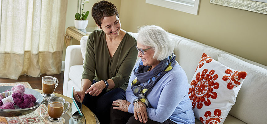 Caregiver and client with electronic device