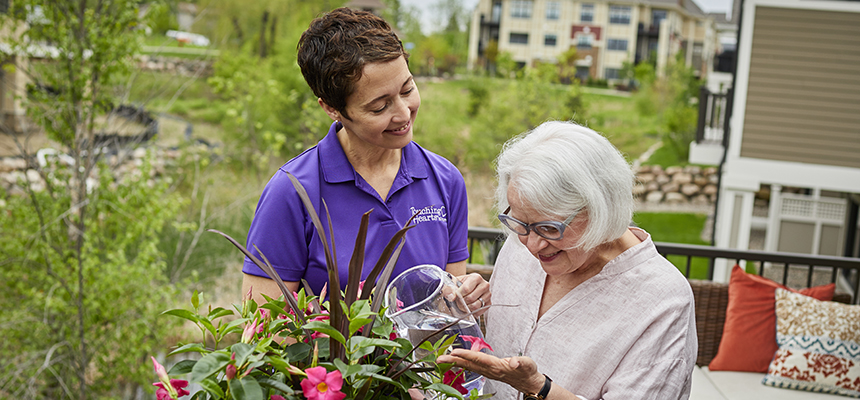 Caregiver and client watering plants