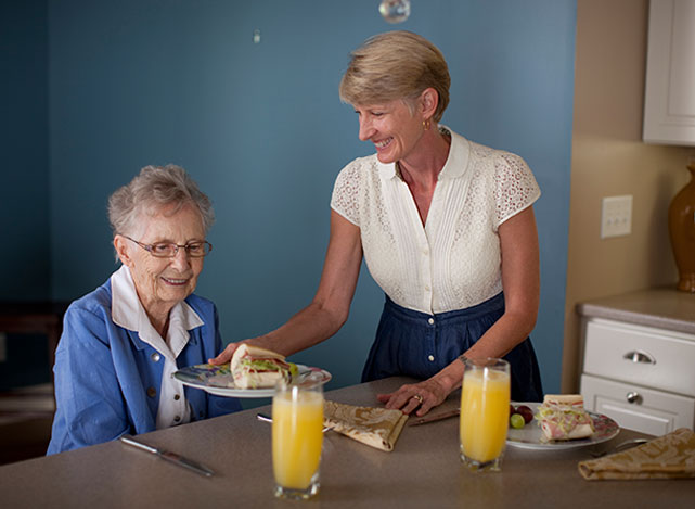 Caregiver preparing a meal for a client